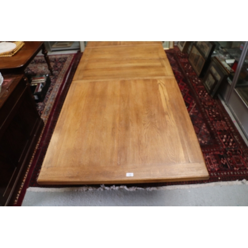 846 - A large oak refectory table, the rectangular top inset with two extra leaves, on chamfered square le... 