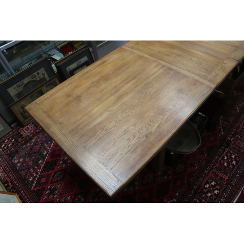 846 - A large oak refectory table, the rectangular top inset with two extra leaves, on chamfered square le... 