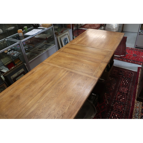 846 - A large oak refectory table, the rectangular top inset with two extra leaves, on chamfered square le... 