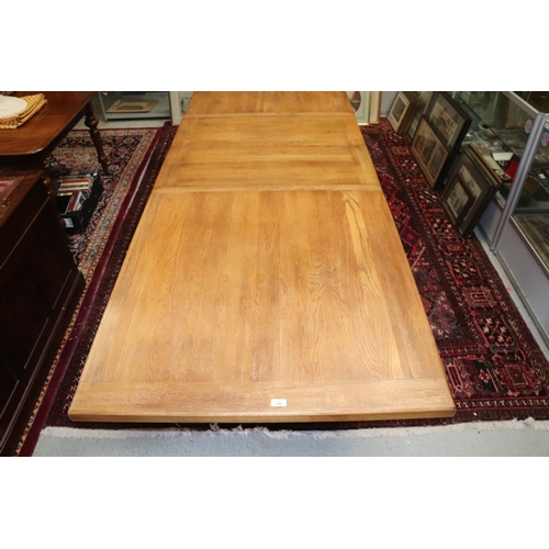 846 - A large oak refectory table, the rectangular top inset with two extra leaves, on chamfered square le... 