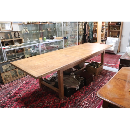 846 - A large oak refectory table, the rectangular top inset with two extra leaves, on chamfered square le... 