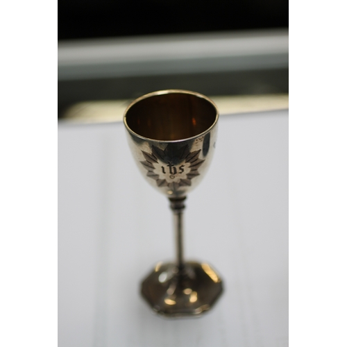 544 - An early Victorian silver communion set comprising chalice, paten and holy water bottle, London 1854... 