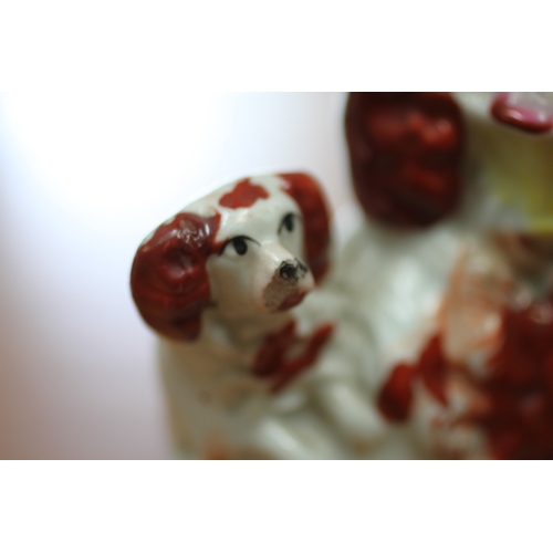 312 - A rare 19th century Staffordshire flatback inkwell group depicting a spaniel holding a basket of flo... 