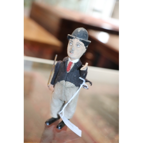 360 - An early 20th century Schuco clockwork model of Charlie Chaplin with fabric covered clothes, approx ... 