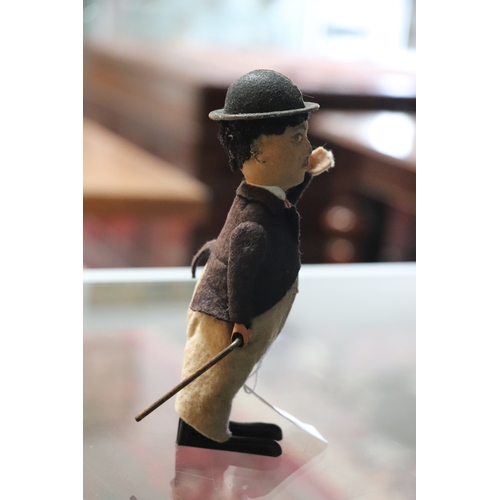 360 - An early 20th century Schuco clockwork model of Charlie Chaplin with fabric covered clothes, approx ... 