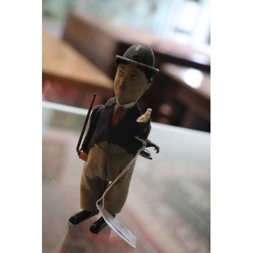 360 - An early 20th century Schuco clockwork model of Charlie Chaplin with fabric covered clothes, approx ... 