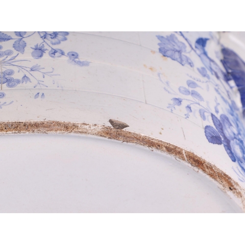 235 - A 19th century blue & white oval footbath decorated with flowers, fruit and birds, 50cms wide.Condit... 