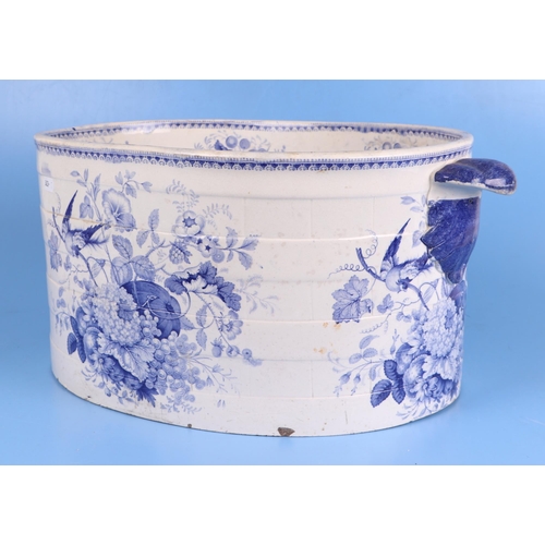 235 - A 19th century blue & white oval footbath decorated with flowers, fruit and birds, 50cms wide.Condit... 