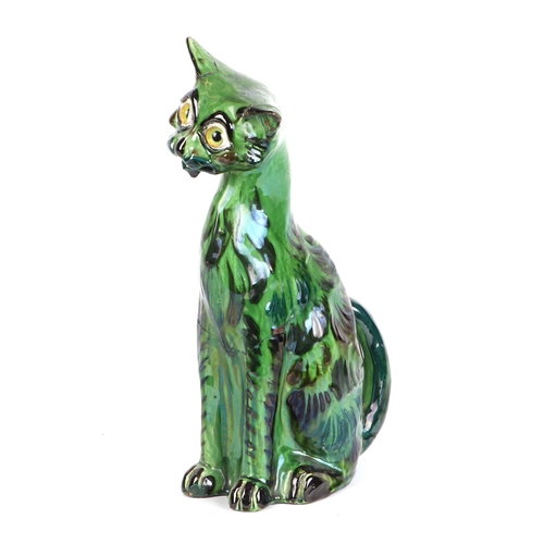 243 - A C H Brannam Art pottery cat with glass eyes, 33cms high (a/f).