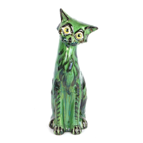 243 - A C H Brannam Art pottery cat with glass eyes, 33cms high (a/f).