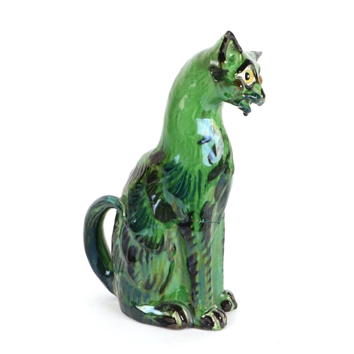 243 - A C H Brannam Art pottery cat with glass eyes, 33cms high (a/f).