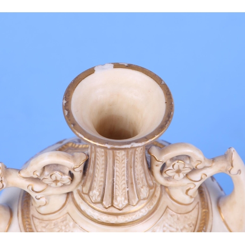 246 - A Royal Worcester blush ivory twin-handled baluster vase, model no. 1200, decorated in relief with g... 