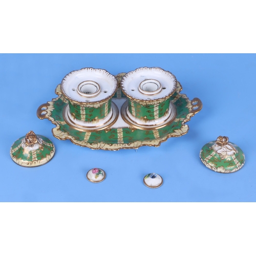 248 - A Victorian porcelain double inkwell with gilded decoration on a green ground, 20cms wide; together ... 