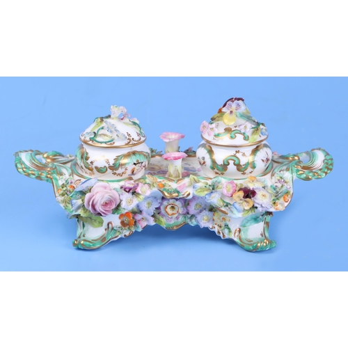 252 - A 19th century porcelain flower encrusted double inkwell, 23cms wide.