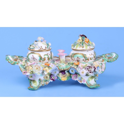 252 - A 19th century porcelain flower encrusted double inkwell, 23cms wide.