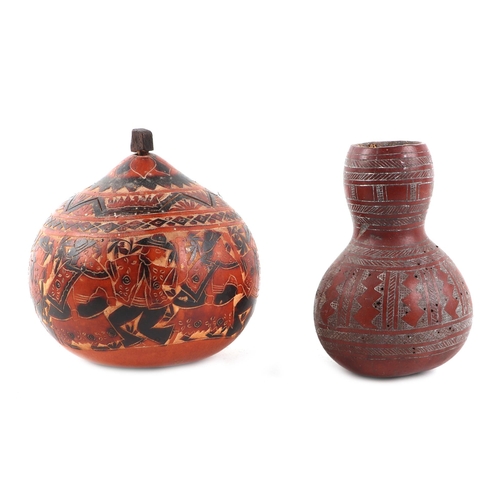 262 - Two gourds with geometric carved decoration, largest 13cms high (2).