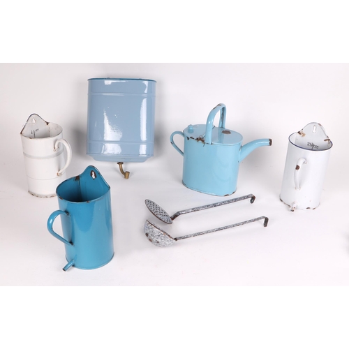 316 - A large quantity of vintage enamelware to include measures, water jug and ladle rack.