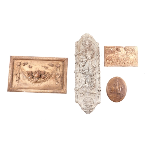 324 - A group of plaster plaques to include cherubs, animals and swags, the largest 46cms high.