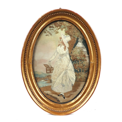 33 - A 19th century silk needlework oval panel depicting a young lady with white dress and bonnet holding... 