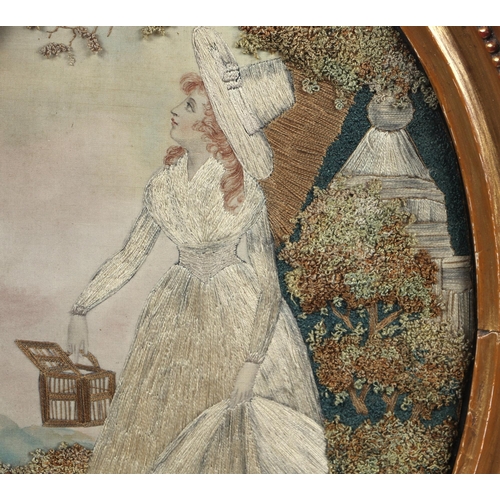 33 - A 19th century silk needlework oval panel depicting a young lady with white dress and bonnet holding... 