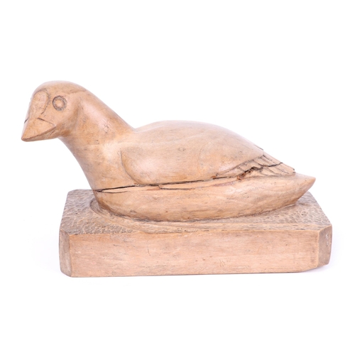 336 - Folk Art:  A wooden carving of a duck resting on a plinth.