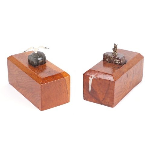 338 - A pair of oak doorstops, each inset with a piece of serpentine marble (2).