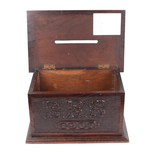 344 - An early 20th century carved oak country house letters box, initialled 'EBS' and dated 1907, 32cms w... 