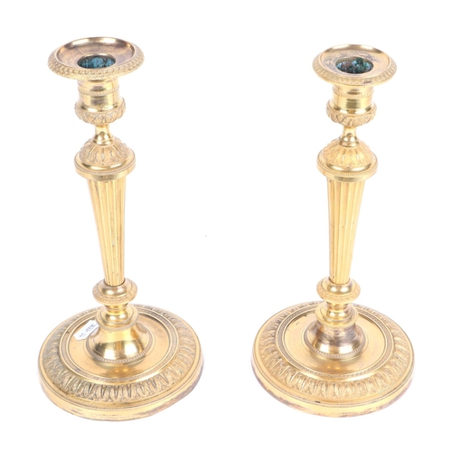 346 - A pair of Louis XVI style gilt bronze candlesticks, 26cms high.