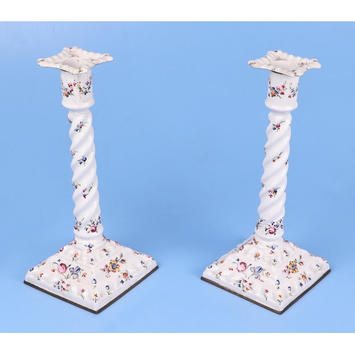 347 - A pair of late 18th century South Staffordshire enamel candlesticks decorated with sprays of flowers... 