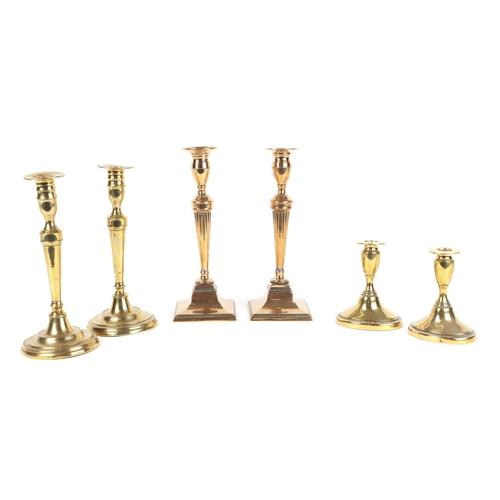 348 - Three pairs of 19th century brass candlesticks, the largest 27cms high (6).