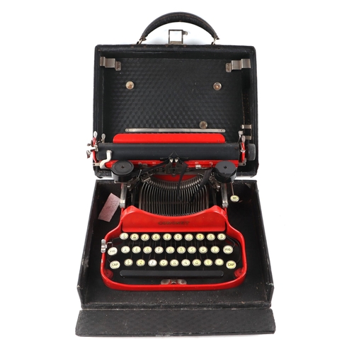 355 - A red Coronet typewriter, cased, 31cms wide.