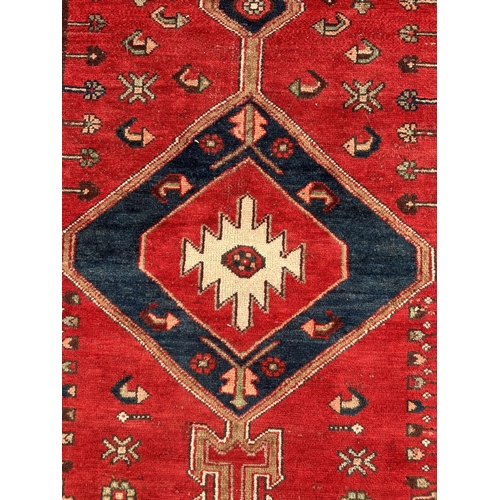 36 - A Persian hand knotted Hamadan runner of geometric design with three central medallions and stylised... 