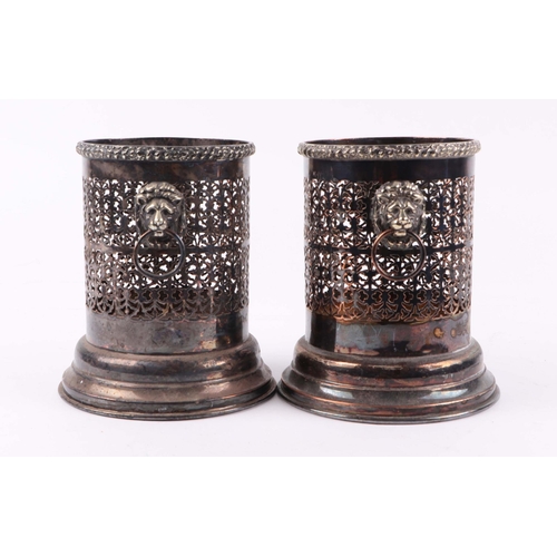 415 - A pair of pierced silver plated bottle holders with lion mask handles. 17cm high