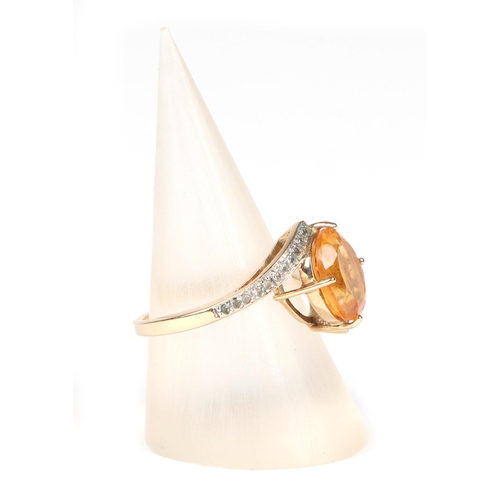 433 - A 9ct gold ring set with an oval Citrine and diamond set shoulders, approx UK size N, 3.2g.