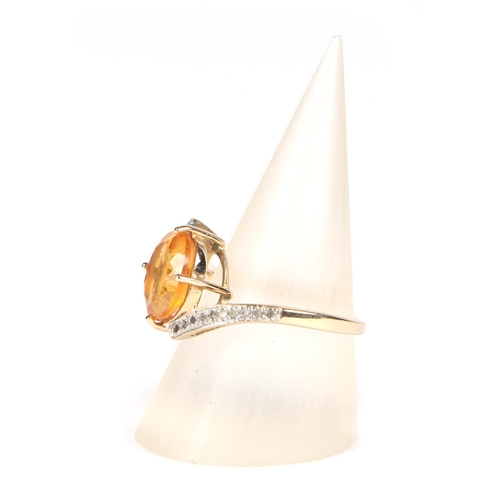 433 - A 9ct gold ring set with an oval Citrine and diamond set shoulders, approx UK size N, 3.2g.