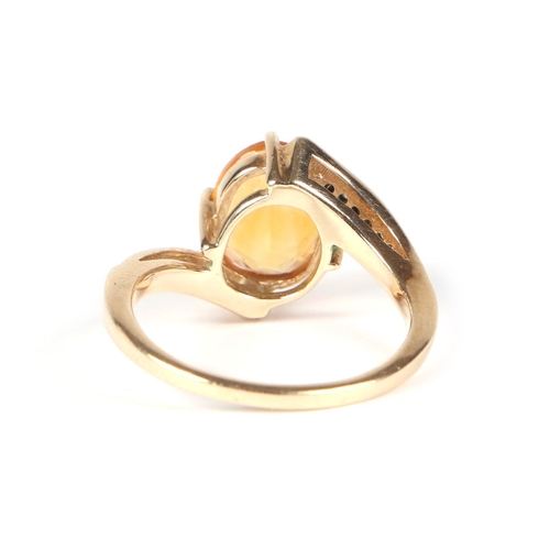 433 - A 9ct gold ring set with an oval Citrine and diamond set shoulders, approx UK size N, 3.2g.