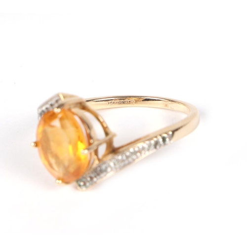 433 - A 9ct gold ring set with an oval Citrine and diamond set shoulders, approx UK size N, 3.2g.