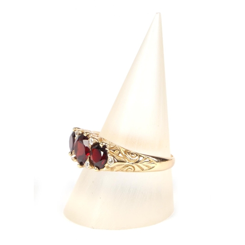 434 - An Edwardian yellow metal three-stone garnet ring interspersed with small diamonds approx UK size P,... 