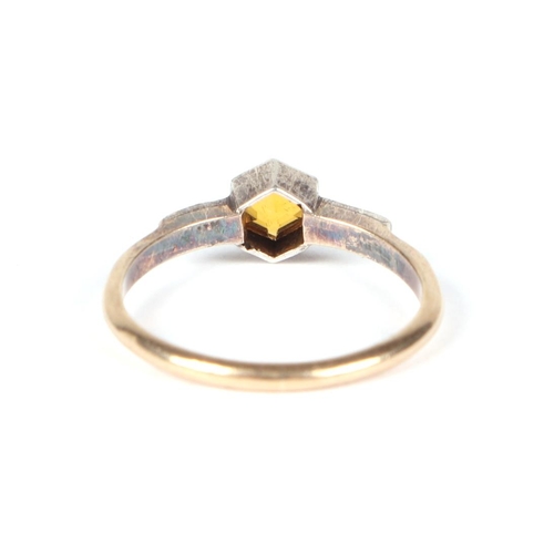 452 - A 9ct gold and silver ring set with a central Citrine, approx UK size O, 1.8g.