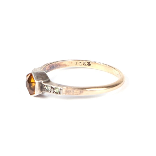 452 - A 9ct gold and silver ring set with a central Citrine, approx UK size O, 1.8g.