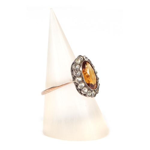 455 - A 9ct gold and silver headed ring set with a central Citrine, approx UK size K, 2.2g.