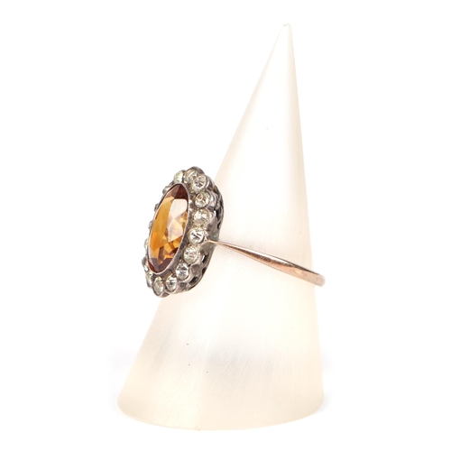 455 - A 9ct gold and silver headed ring set with a central Citrine, approx UK size K, 2.2g.