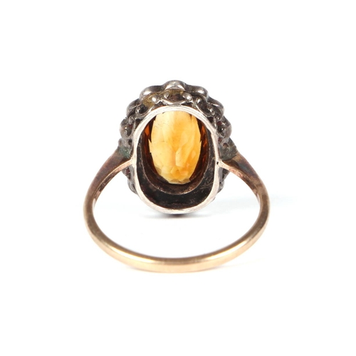 455 - A 9ct gold and silver headed ring set with a central Citrine, approx UK size K, 2.2g.