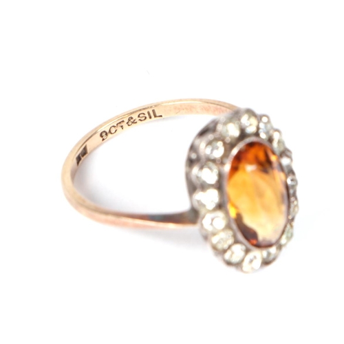 455 - A 9ct gold and silver headed ring set with a central Citrine, approx UK size K, 2.2g.