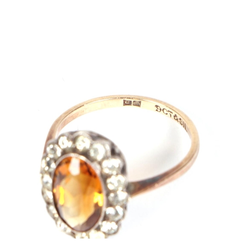 455 - A 9ct gold and silver headed ring set with a central Citrine, approx UK size K, 2.2g.