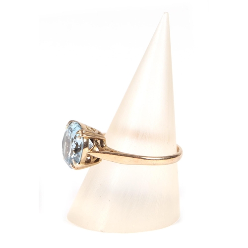 458 - A 9ct gold ring set with a large circular pale blue stone, approx UK size M, 2.7g.