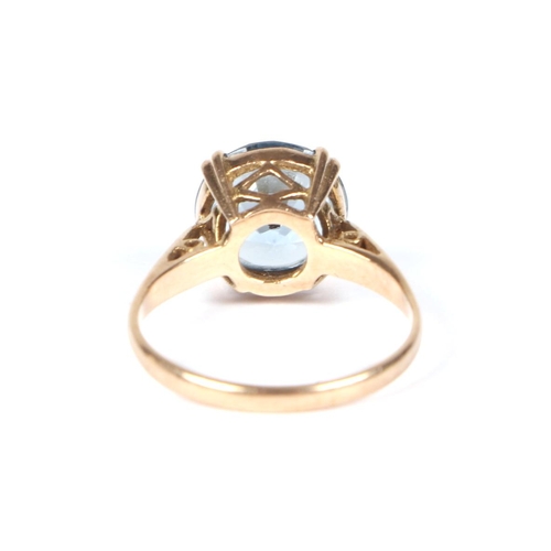 458 - A 9ct gold ring set with a large circular pale blue stone, approx UK size M, 2.7g.