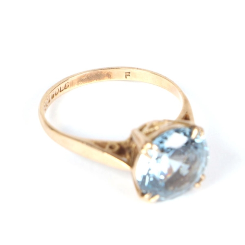 458 - A 9ct gold ring set with a large circular pale blue stone, approx UK size M, 2.7g.