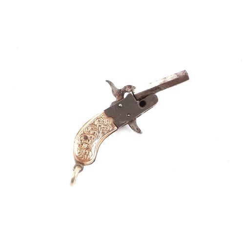 463 - A miniature Austrian working pinfire keyring pistol with yellow metal mounted grip, 4cms long.