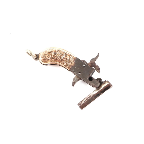 463 - A miniature Austrian working pinfire keyring pistol with yellow metal mounted grip, 4cms long.